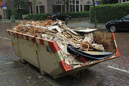 picture of rubbish and wood piled into a garbage unit