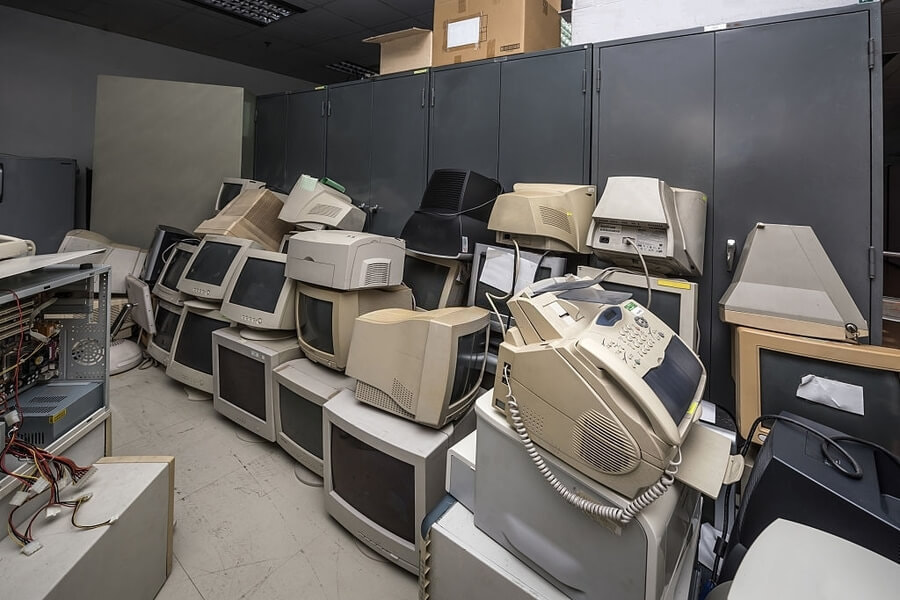picture of a office with a lot of monitors that is not used anymore